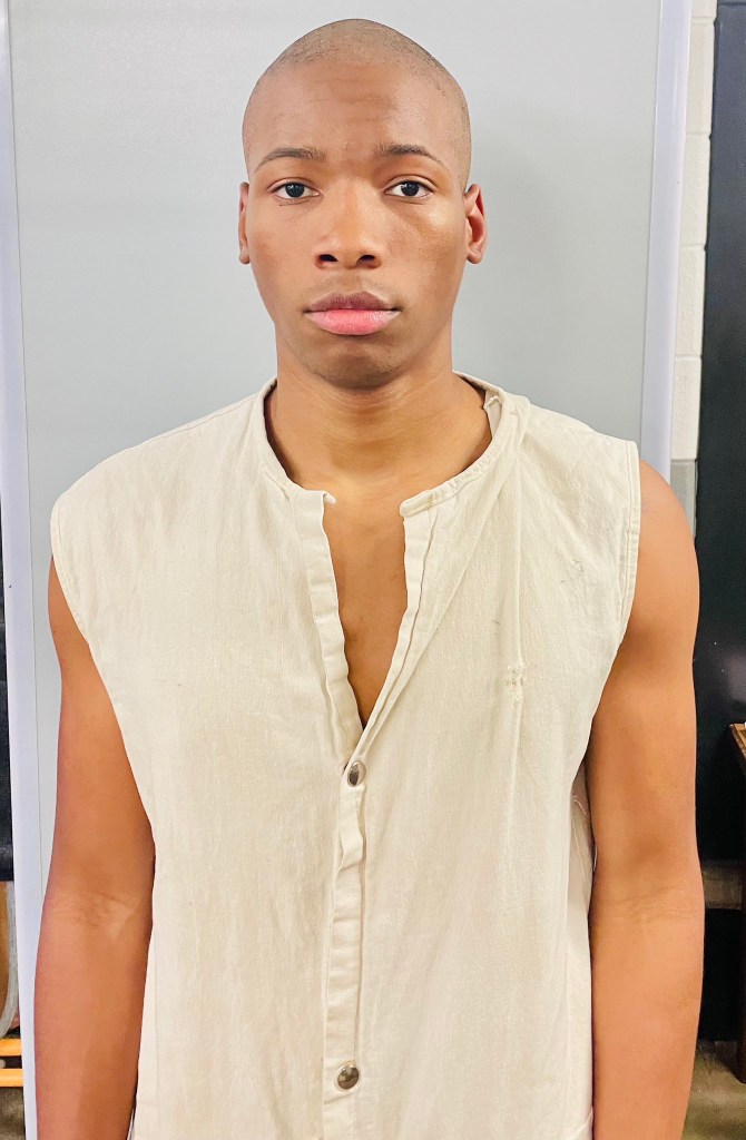 Karmelo Anthony in a light-colored, sleeveless shirt.