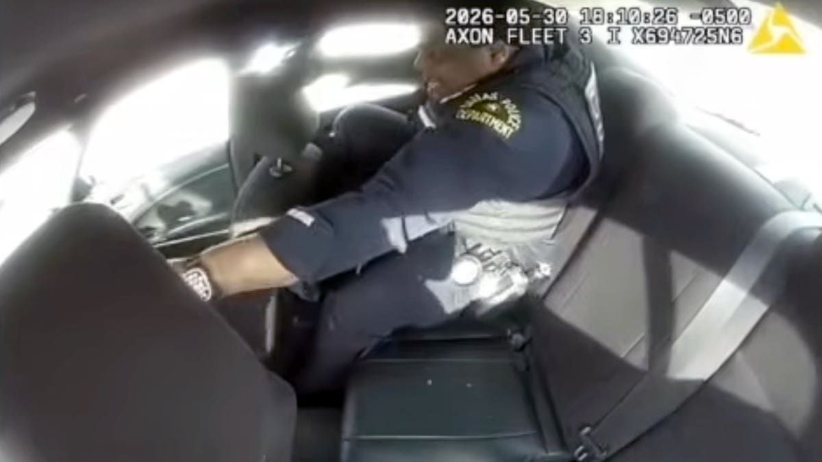 An officer remained inside the patrol car after the suspect allegedly took control of the vehicle.
