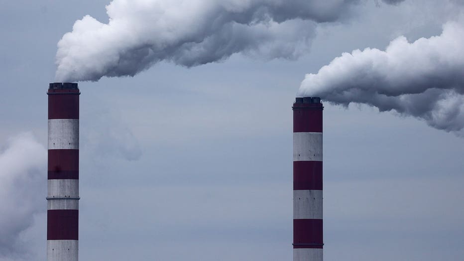 Smokestacks of a power plant are seen in April 2025.
