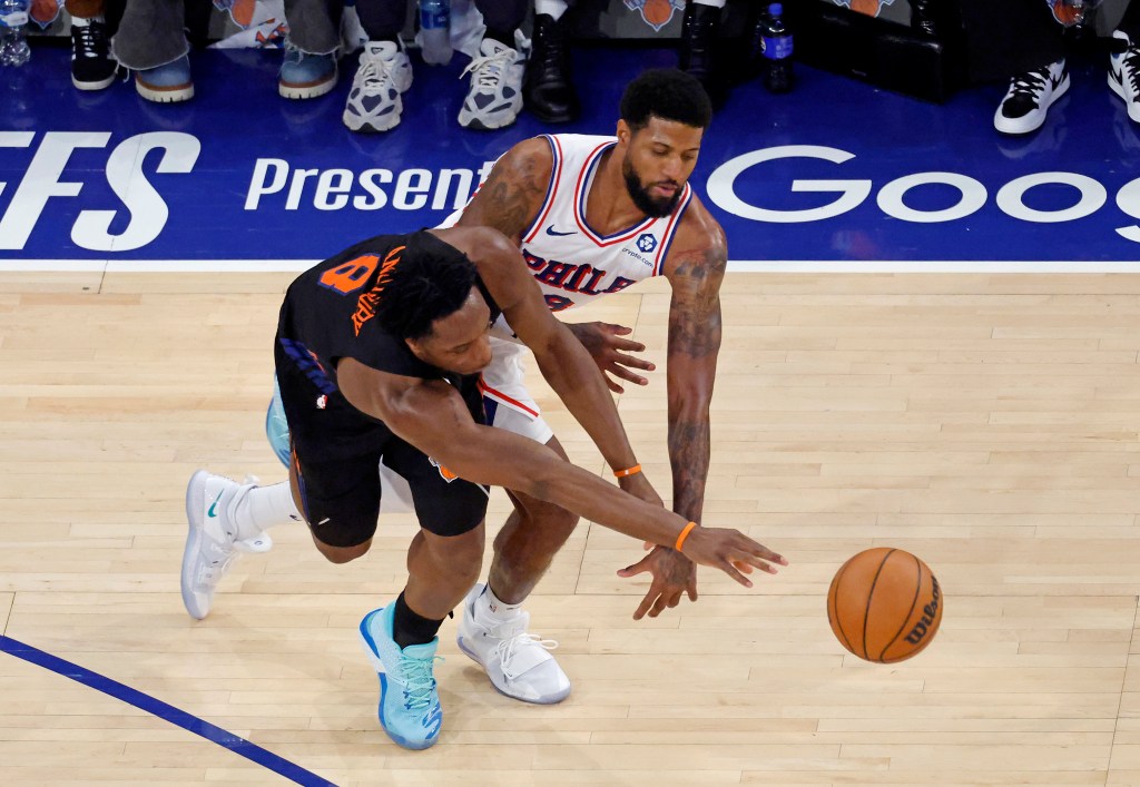 New York Knicks forward Og Anunoby (8) knocks the ball away from Philadelphia 76ers forward Paul George (8).