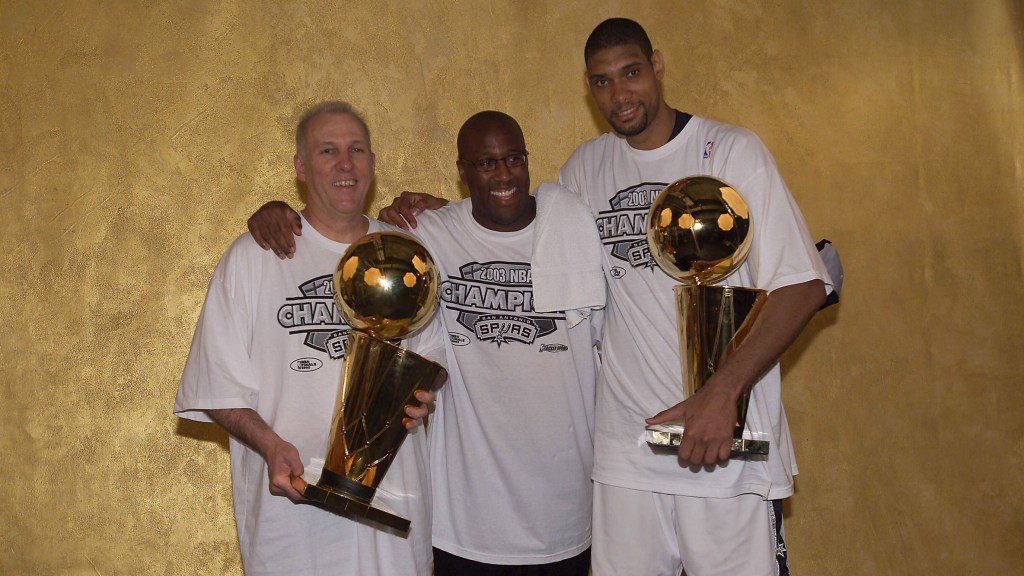 Gregg Popovich, Mike Brown and Tim Duncan are pictured after winning the NBA Finals in 2003.