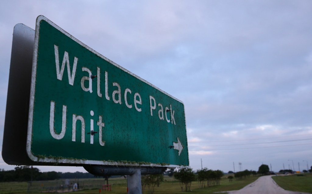 A road sign pointing to the Wallace Pack Unit.