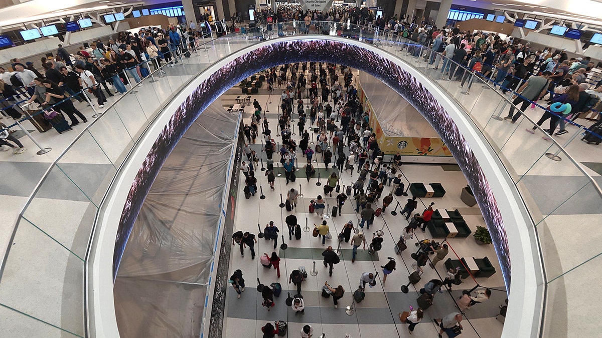 Travelers lining up at a TSA checkpoint inside George Bush Intercontinental Airport in Houston