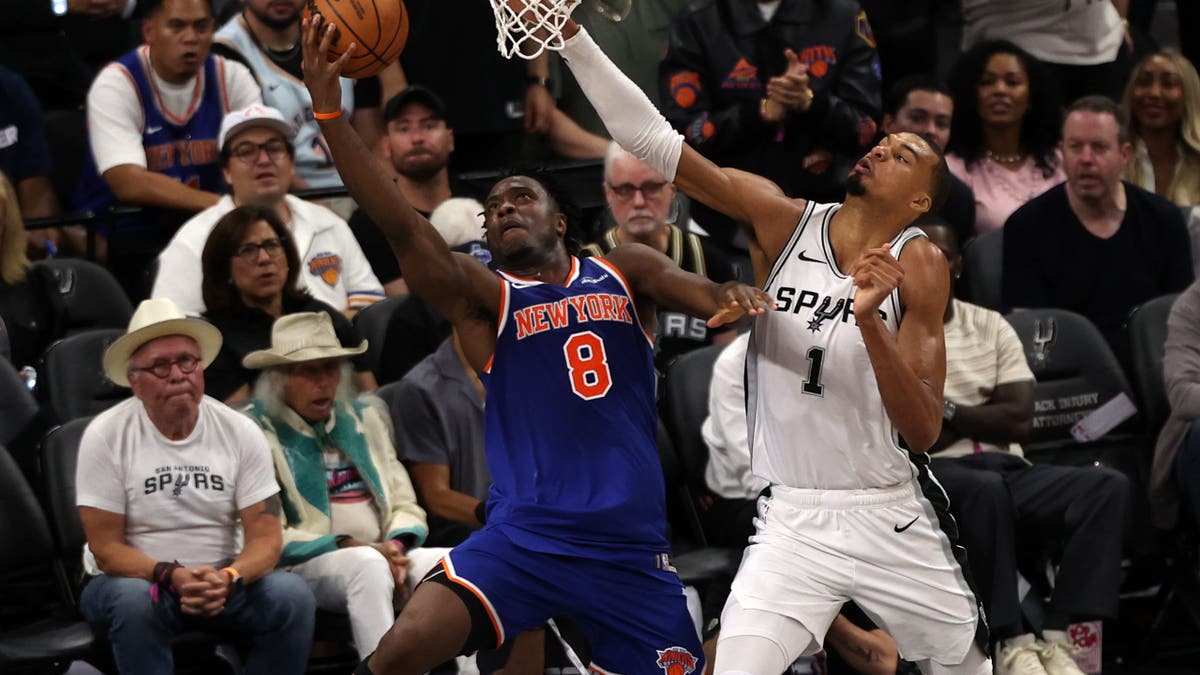 Jun 5, 2026; San Antonio, Texas, USA; New York Knicks forward Og Anunoby (8) shoots the ball against San Antonio Spurs forward Victor Wembanyama (1) in the second half during game two of the 2026 NBA Finals at Frost Bank Center. Mandatory Credit: Geoff Burke-Imagn Images