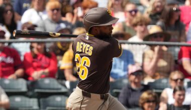 Mar 10, 2026; Tempe, Arizona, USA; San Diego Padres outfielder Pablo Reyes (26) hits a two-RBI single against the Los Angeles Angels in the second inning at Tempe Diablo Stadium. Mandatory Credit: Rick Scuteri-Imagn Images