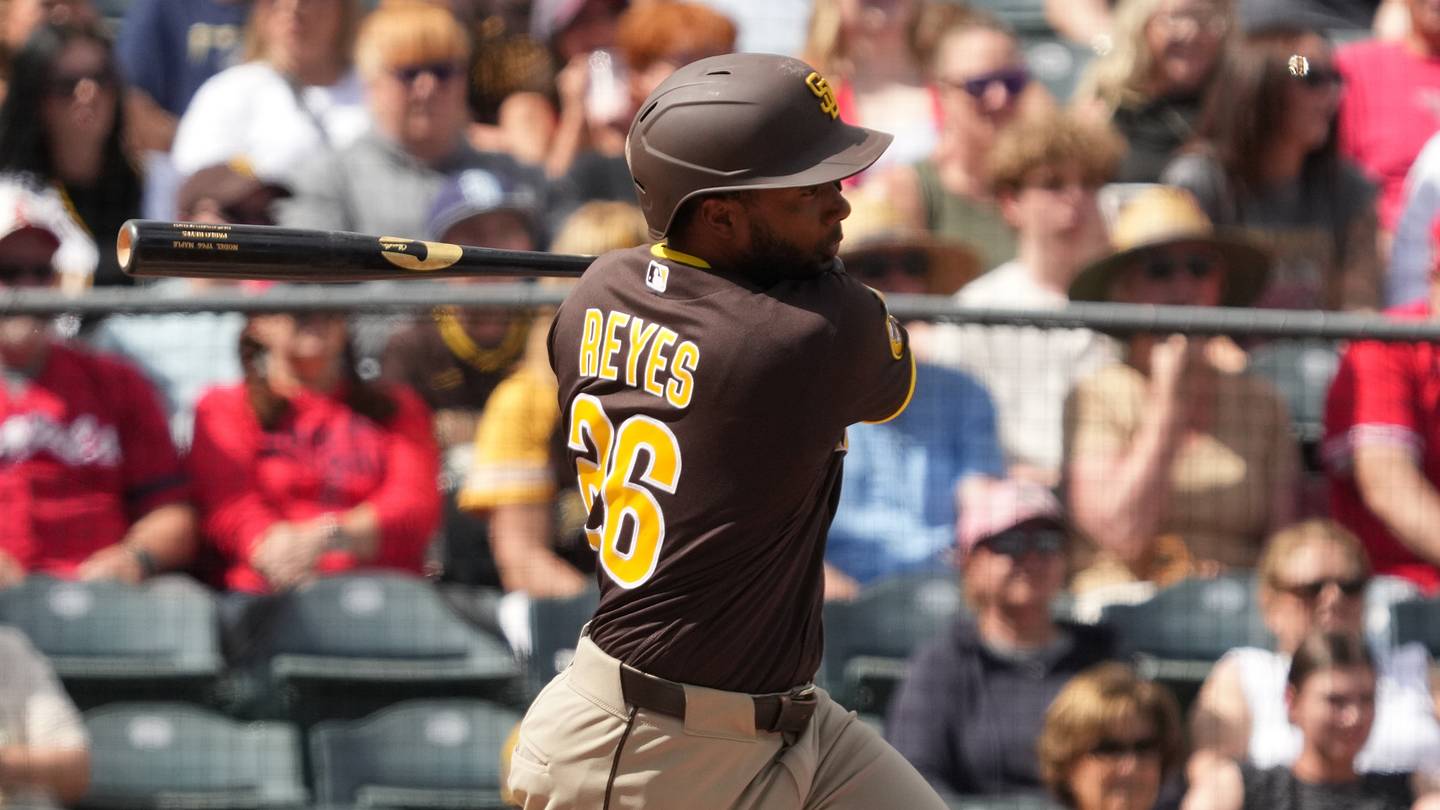 Mar 10, 2026; Tempe, Arizona, USA; San Diego Padres outfielder Pablo Reyes (26) hits a two-RBI single against the Los Angeles Angels in the second inning at Tempe Diablo Stadium. Mandatory Credit: Rick Scuteri-Imagn Images