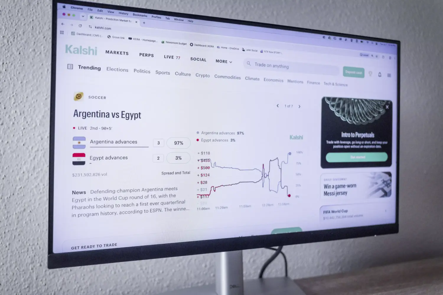 A computer screen displays the homepage of Kalshi, a prediction market platform. The main "market" feature on the website is for the Argentina and Egypt FIFA World Cup game.