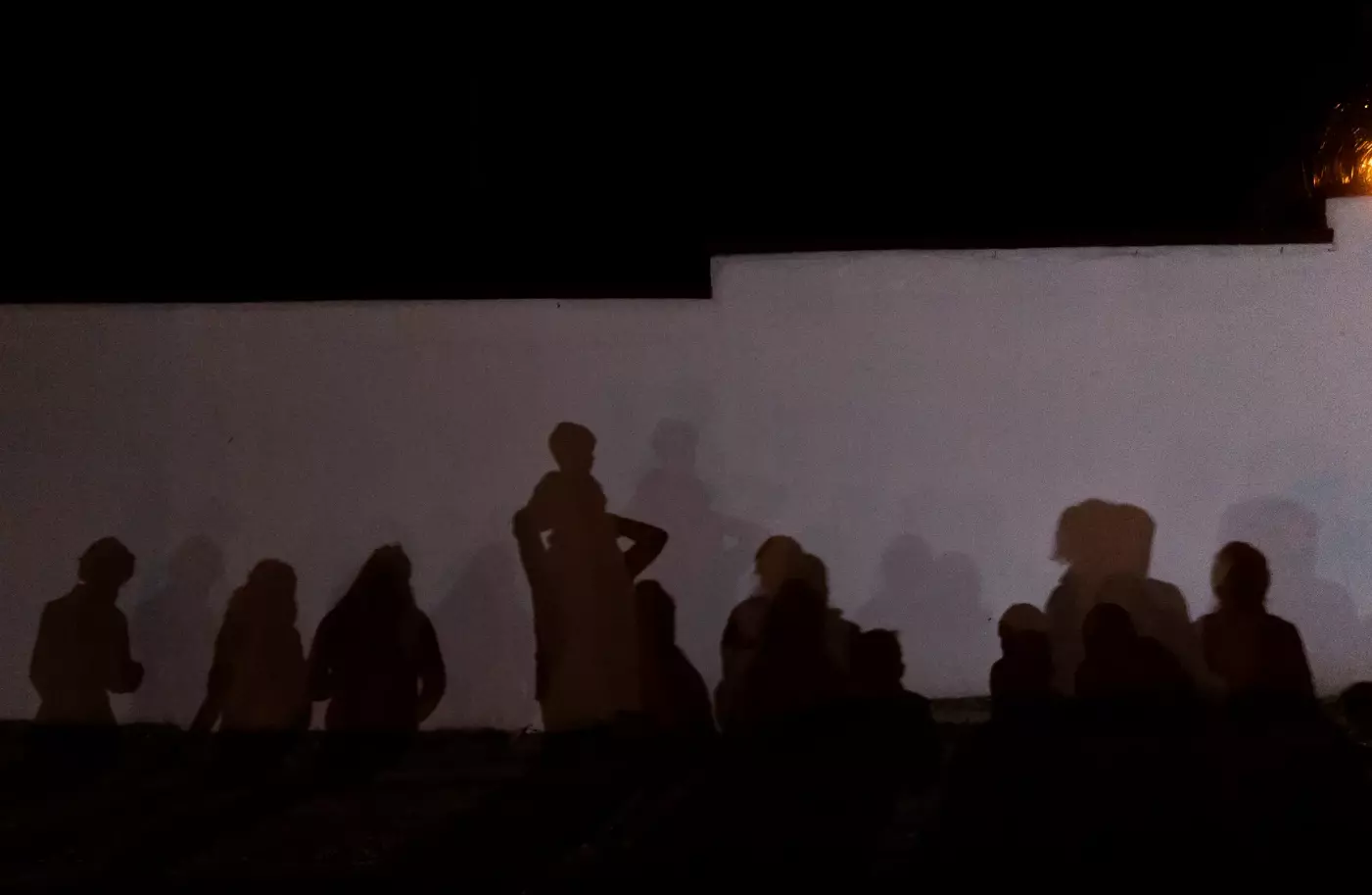 The shadows of asylum seekers are cast on a wall in Roma on Aug. 3, 2021. Roma is on the Texas/Mexico border in Starr County, about 50 miles west of McAllen.