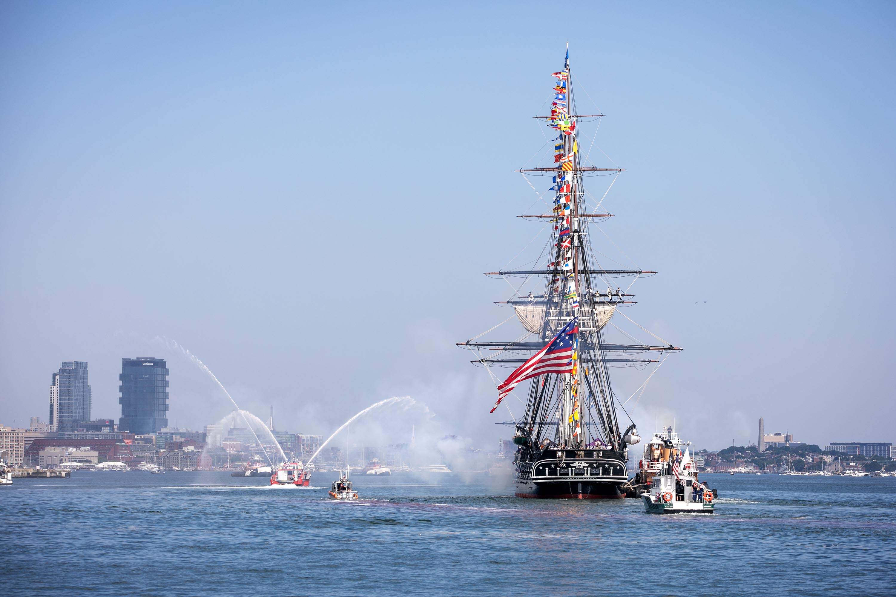 The USS Constitution fires a salute in Boston Harbor. (Robin Lubbock/WBUR)