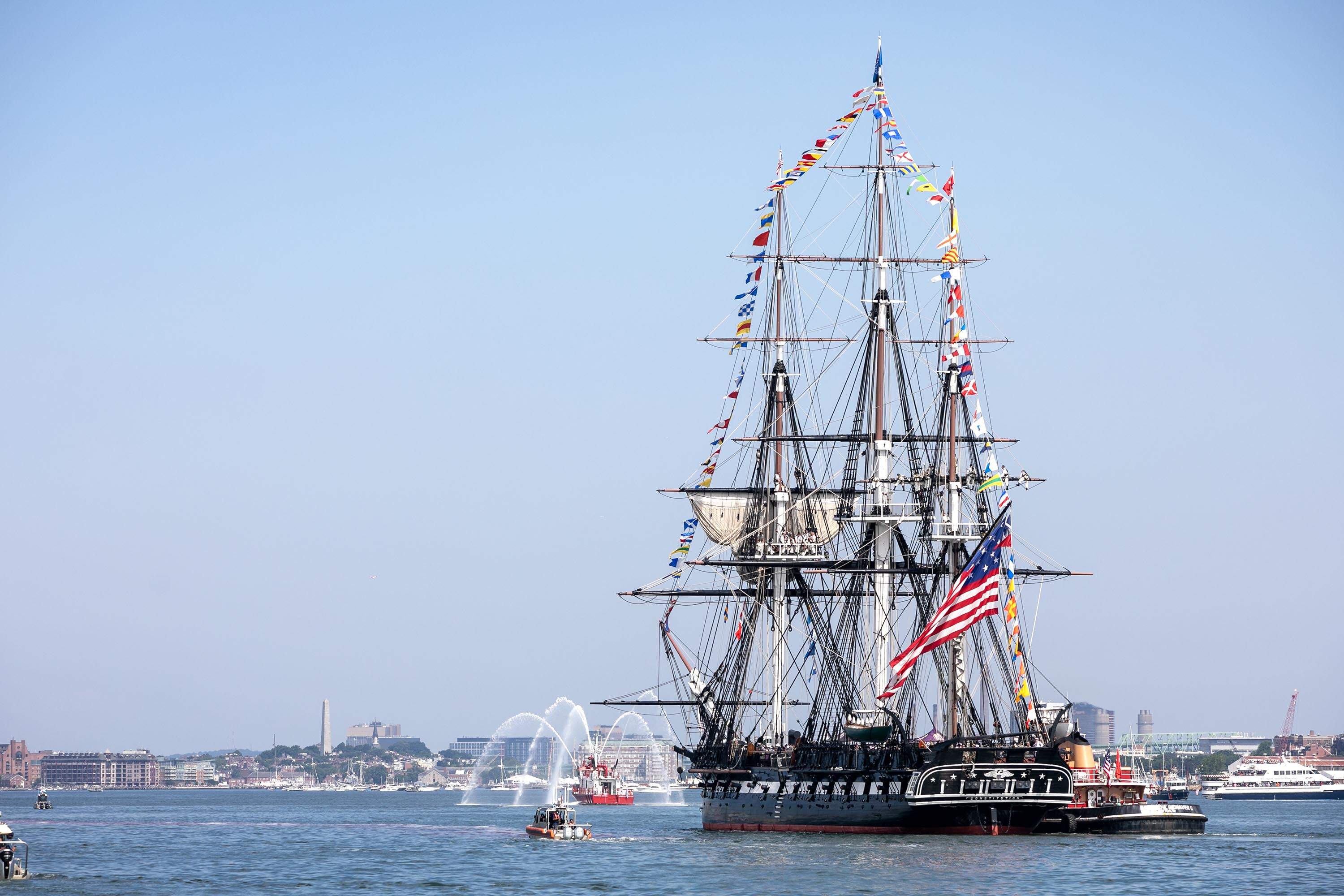 The USS Constitution makes its way across Boston Harbor. (Robin Lubbock/WBUR)