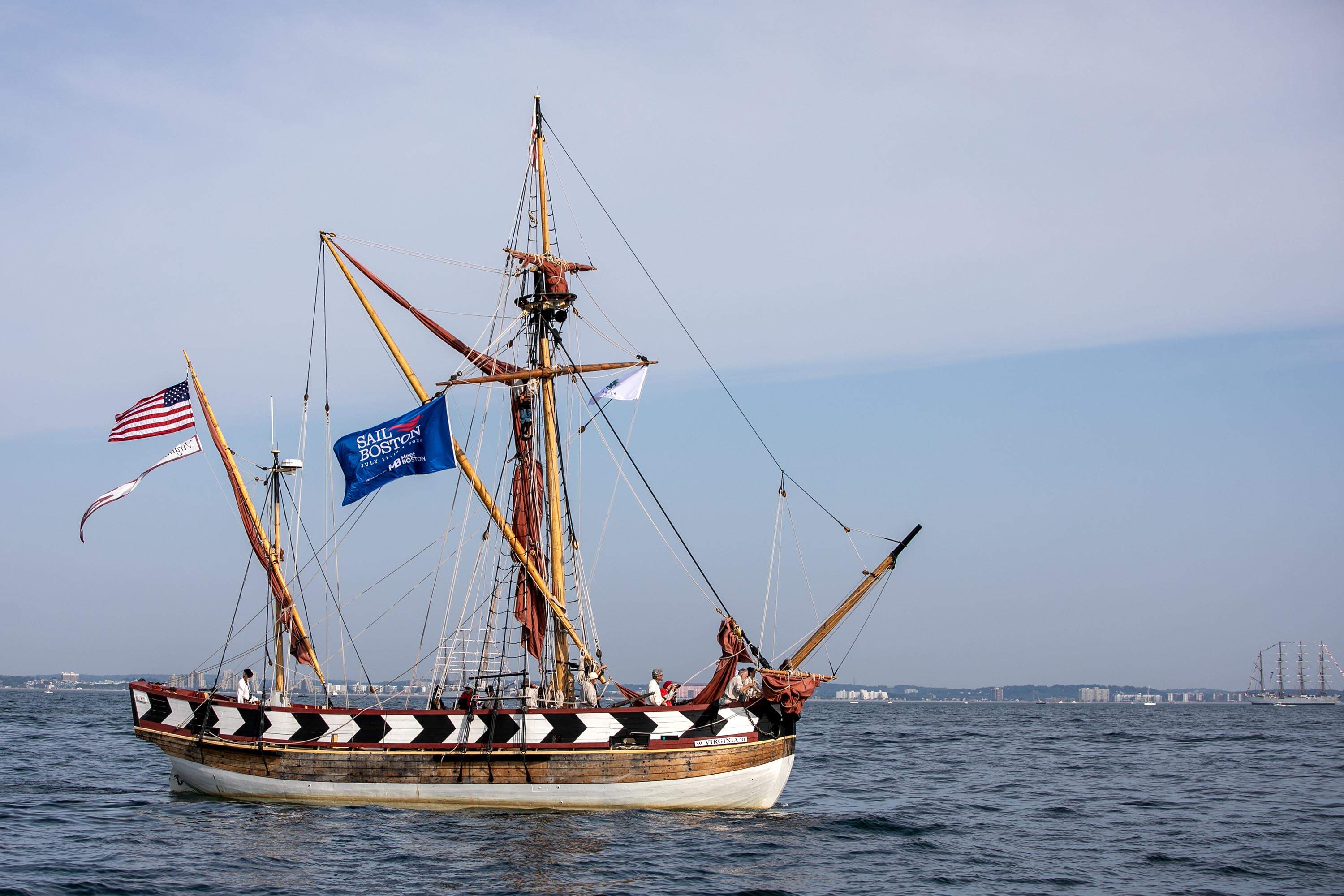 The pinnace Virginia makes its way across Boston Harbor during the 2026 Parade of Sail. (Robin Lubbock/WBUR)
