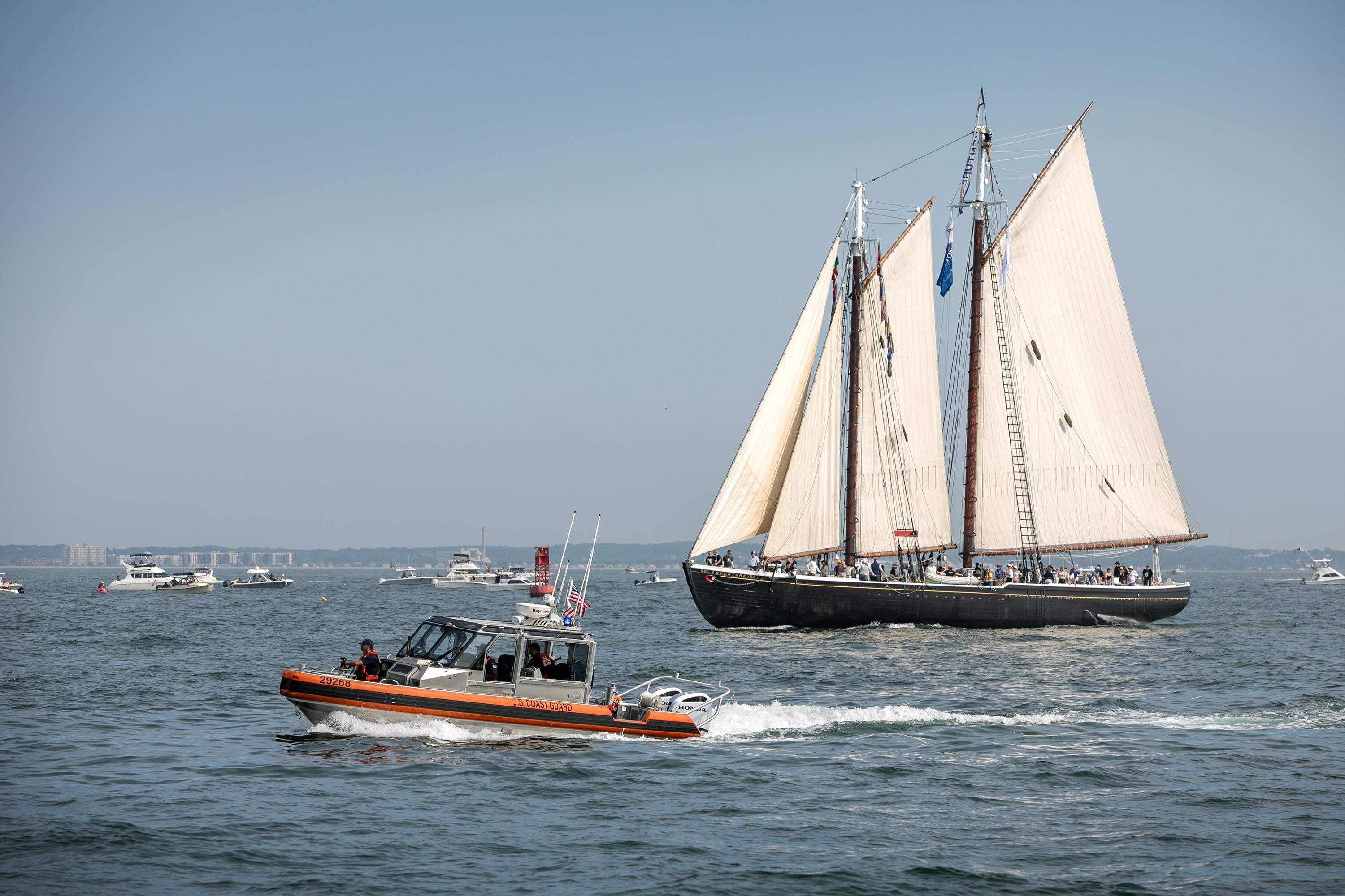 The schooner Adventure makes its way into Boston Harbor during the 2026 Parade of Sail. (Robin Lubbock/WBUR)