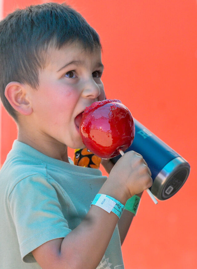 A little boy enjoys a candy apple at the El Paso County Fair on Sunday, July 12, 2026. The El Paso County Fair will continue in Calhan through July 18. (The Gazette, Jerilee Bennett)