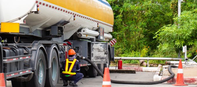 Worker Fueling Up a Freight Transport Truck