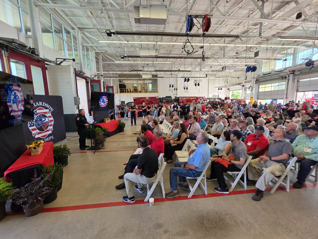 Crowd watching Fire Chief Curtis Poovey speak at the fire department's 100th anniversary celebration