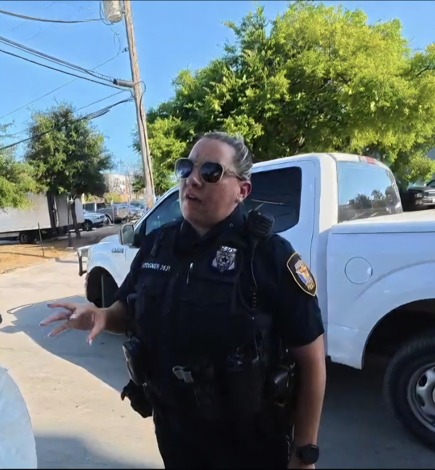 A Fort Worth police officer speaks with a Christian evangelist group at a pride rally in Fort Worth, Texas, on June 27, 2026. 