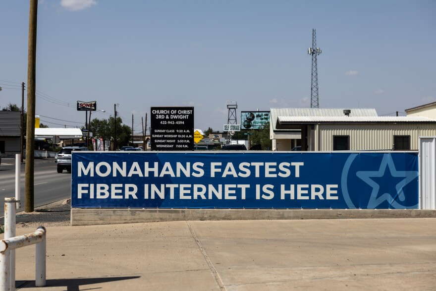 A banner reading Monahans fastest fiber internet is here is shown in a town.