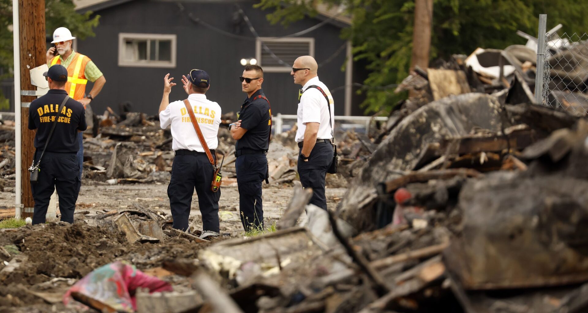 Investigators from Dallas Fire-Rescue inspect the leveled The Clyde apartments on East 9th St near Patton Avenue in the Oak Cliff area of Dallas, May 30, 2026. The apartment building exploded and burst into flames, Thursday.