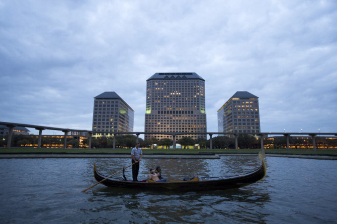 Gondolas move along the water before stopping for passengers at the revived Canal Fest, on Oct. 19, 2013 at Las Colinas in Irving.