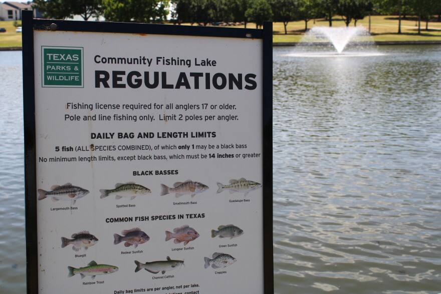 A Texas Parks and Wildlife Department sign outlines regulations along the edge of Boys Ranch Lake in Bedford. July 2, 2026.