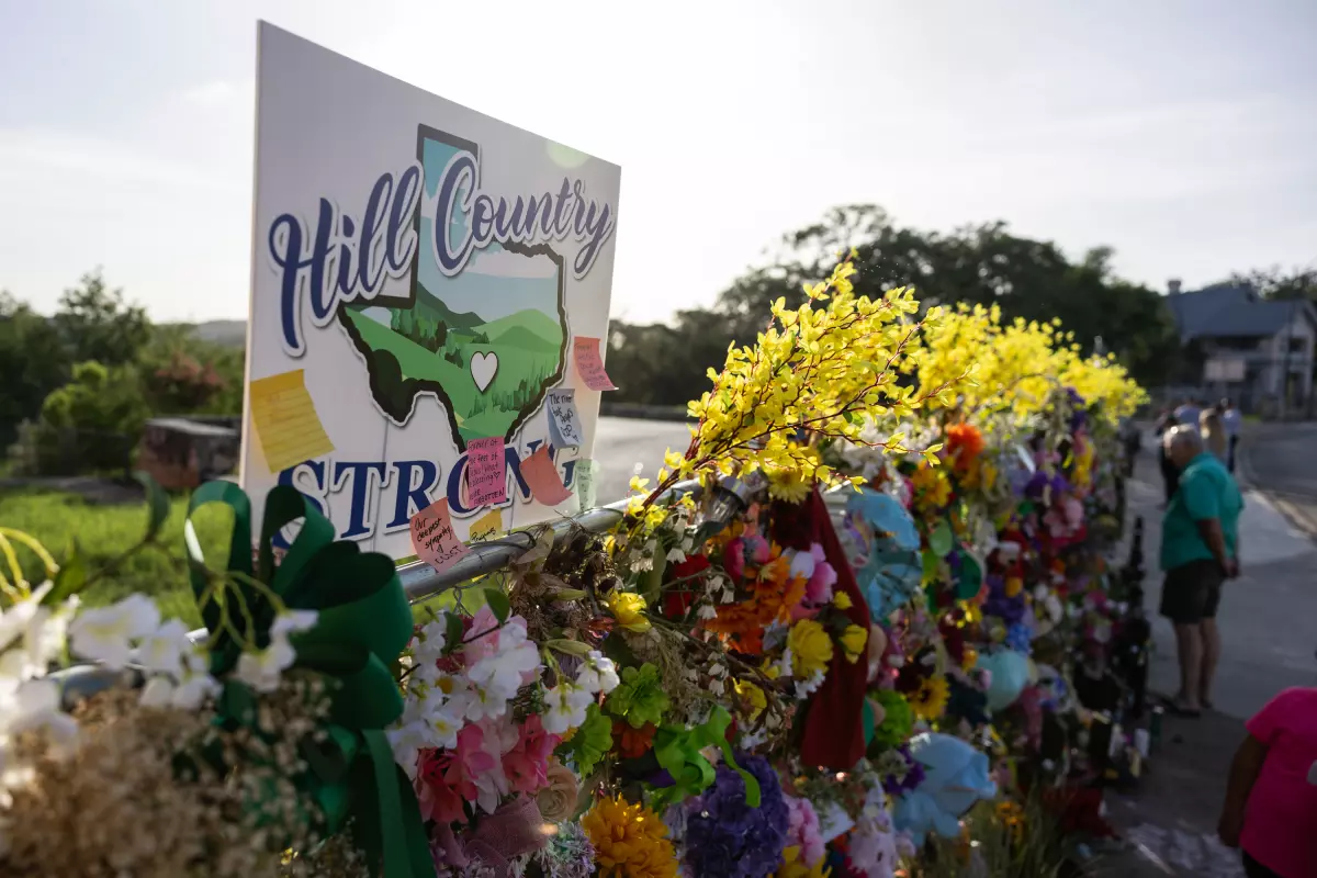 A Hill Country Strong sign is pictured among flowers for victims of the July Fourth flooding on Thursday, July 17, 2025, in Kerrville, Texas.