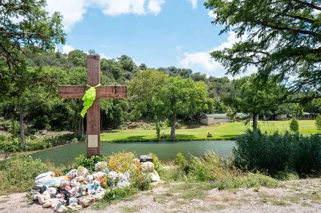 A makeshift memorial dedicated to the lives of the 25 girls and two teenage counselors who were killed during last year's Texas Hill Country flash floods is seen on June 24, 2026 in Hunt, Texas.