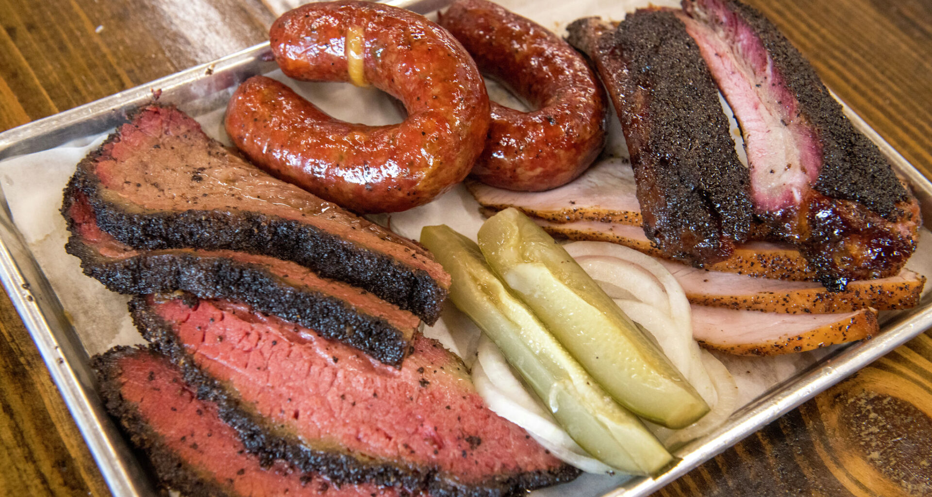 Plate of barbecued meats at Mum Foods Smokehouse and Delicatessen, Austin, Texas, June 16, 2023.