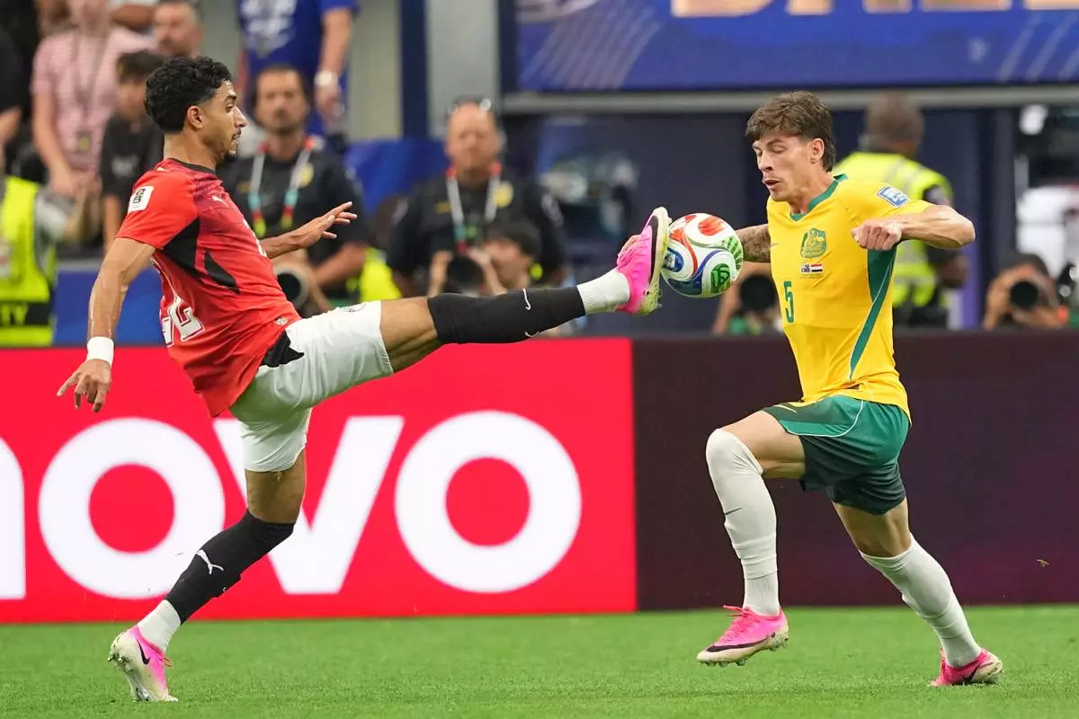 Egypt's Omar Marmoush, left, and Australia's Jordan Bos vie for the ball during a World Cup round of 32 soccer match in Arlington, Texas, near Dallas, Friday, July 3, 2026. (AP Photo/Julio Cortez)