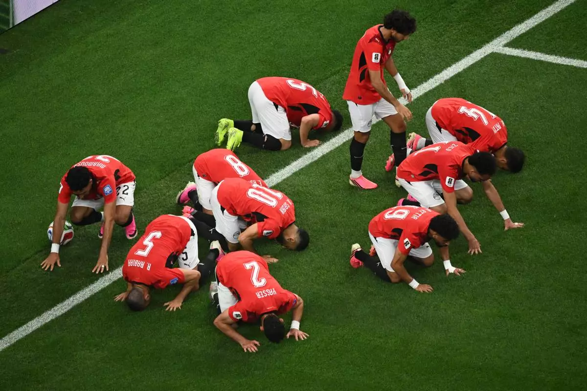 Egypt players bow in prayer after scoring opening goal during the World Cup round of 32 soccer match between Australia and Egypt in Arlington, Texas, near Dallas, Friday, July 3, 2026. (AP Photo/Jessica Tobias)