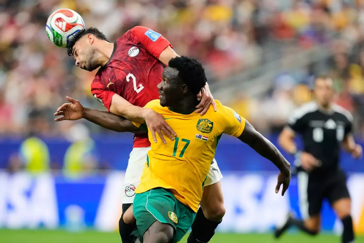 Egypt's Yasser Ibrahim (2) and Australia's Nestory Irankunda fight for the ball during the World Cup round of 32 soccer match in Arlington, Texas, near Dallas, Friday, July 3, 2026. (AP Photo/Tony Gutierrez)