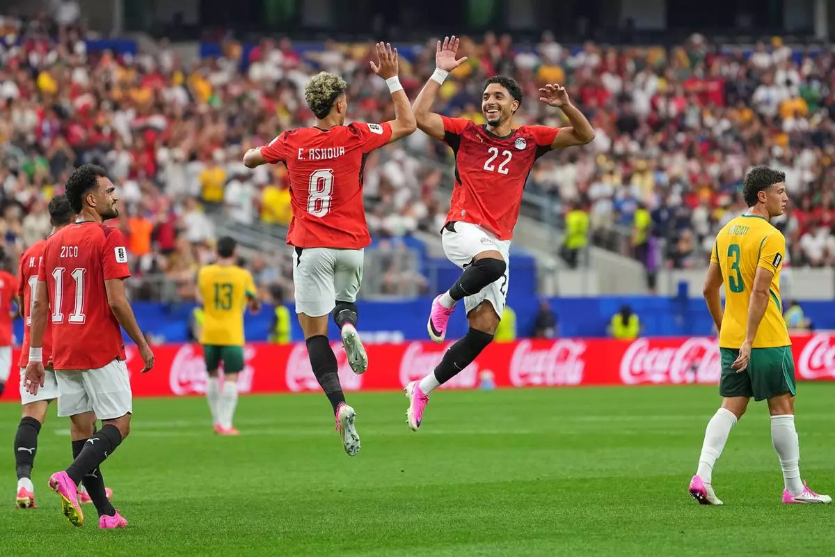 Egypt's Emam Ashour (8) celebrates with Omar Marmoush after scoring the opening goal during a World Cup round of 32 soccer match between Australia and Egypt in Arlington, Texas, near Dallas, Friday, July 3, 2026. (AP Photo/Julio Cortez)