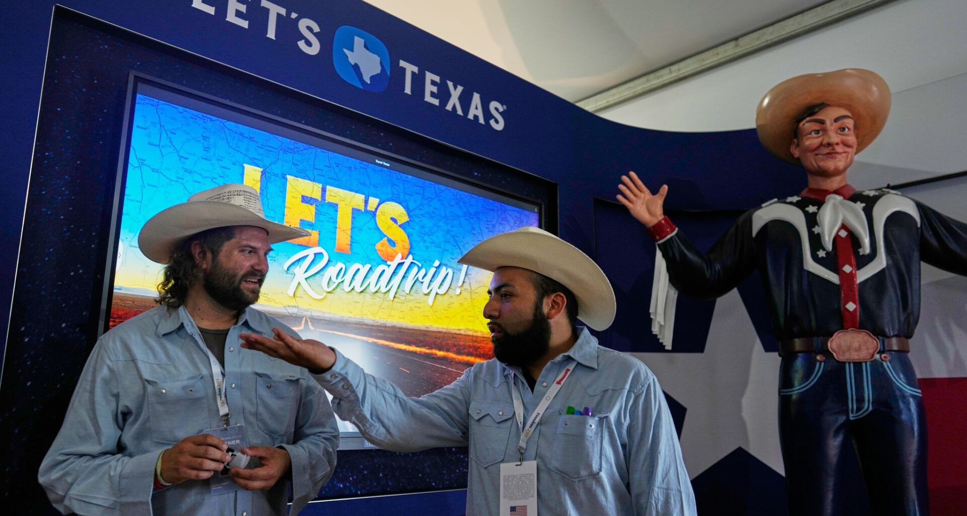 Exhibit staffers on Friday at the Texas display with a mini-sized Big Tex at the Great American State Fair in Washington.