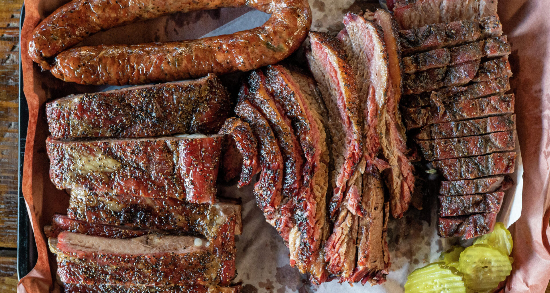 Sausage, ribs, brisket and pork steak are all displayed on a tray at Snow's BBQ on July 31, 2021 in Lexington, Texas.