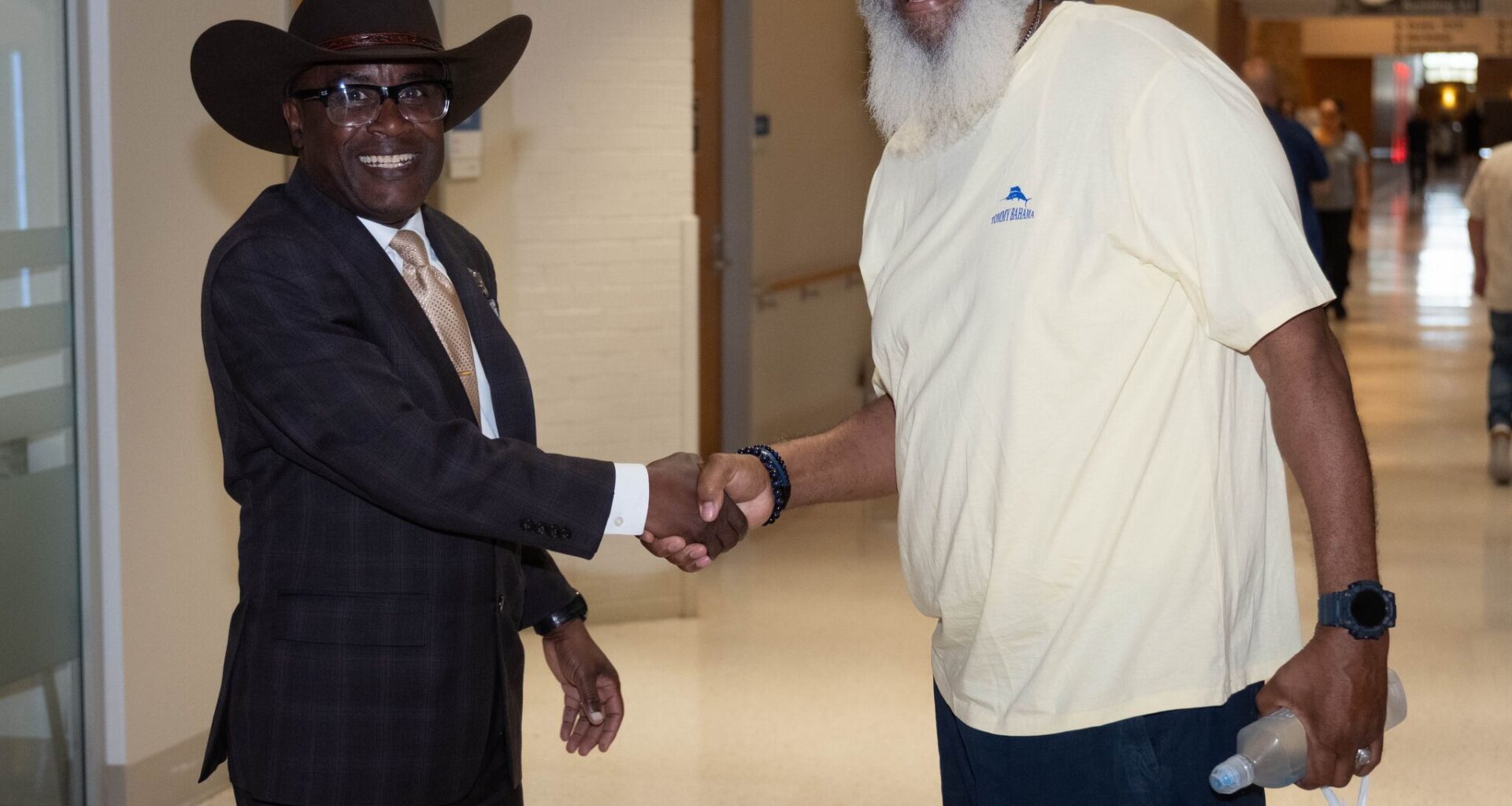 VA North Texas Health Care System Associate Director James Douglas (left) shares a handshake with a veteran.  