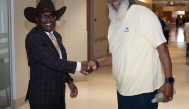 VA North Texas Health Care System Associate Director James Douglas (left) shares a handshake with a veteran.  