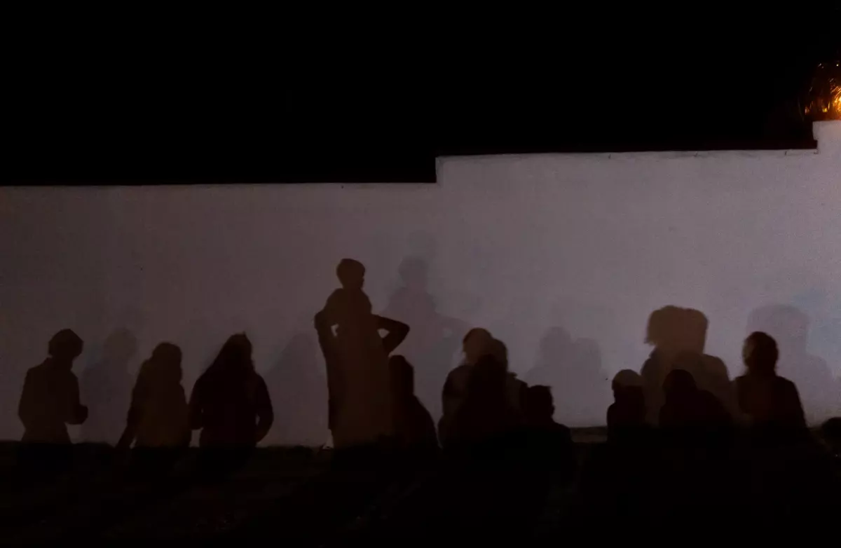 The shadows of asylum seekers are cast on a wall in Roma on Aug. 3, 2021. Roma is on the Texas/Mexico border in Starr County, about 50 miles west of McAllen.