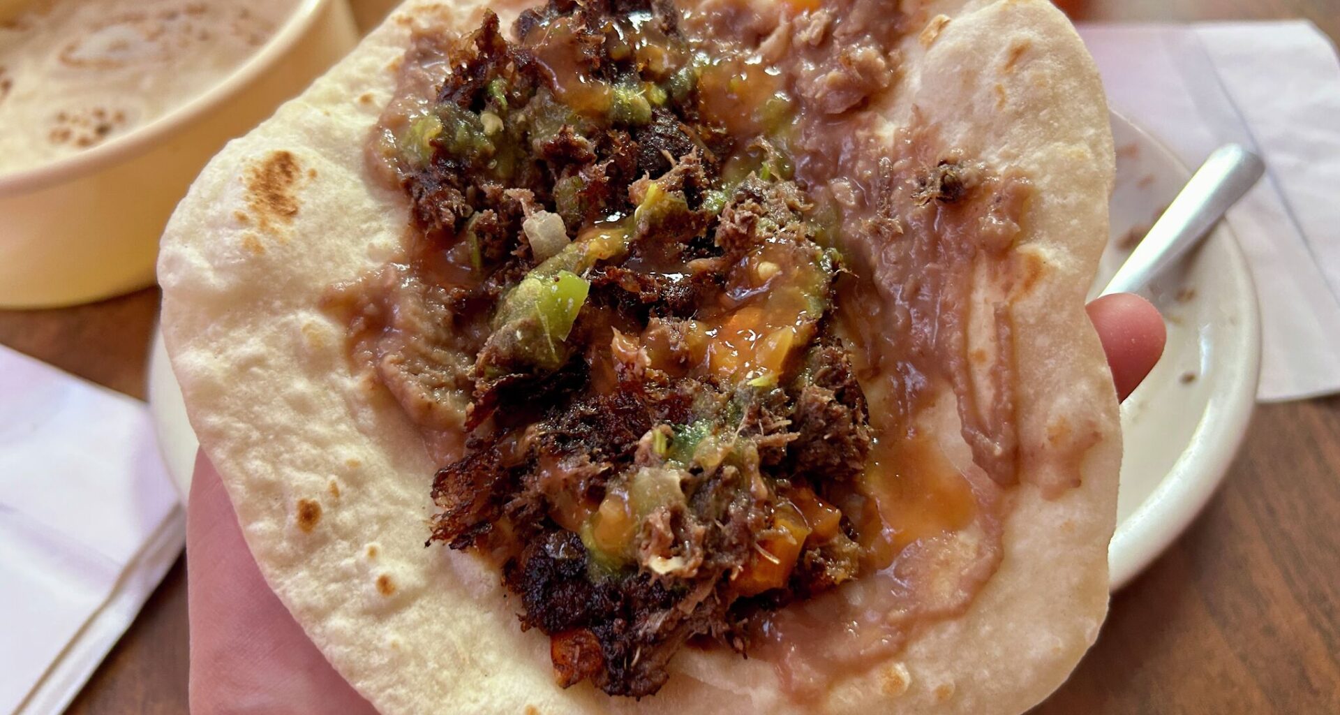 Barbacoa guisada taco with beans and salsa from Mittman Fine Foods. 