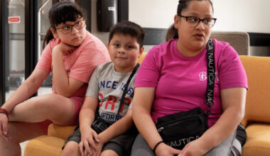 Estfania Herrera sits with her two children as she talks about the lack of help from the management of The Bonnie apartments property management.