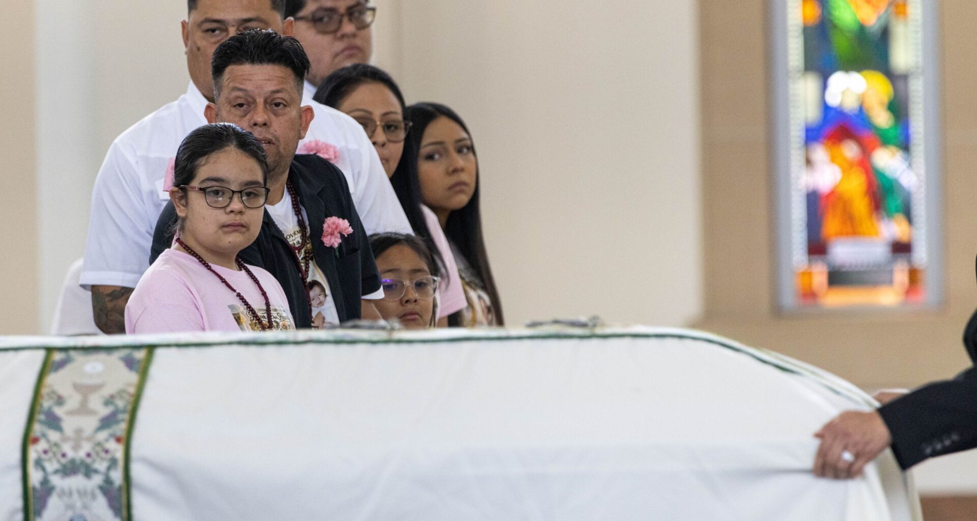 Erik and daughter Vanessa Pérez watch as the casket of Marisol and Erik Jr. Pérez who died in a late May apartment fire is wheeled past out of St. Cecilia Catholic Parish Dallas, Tuesday, June 9, 2026.