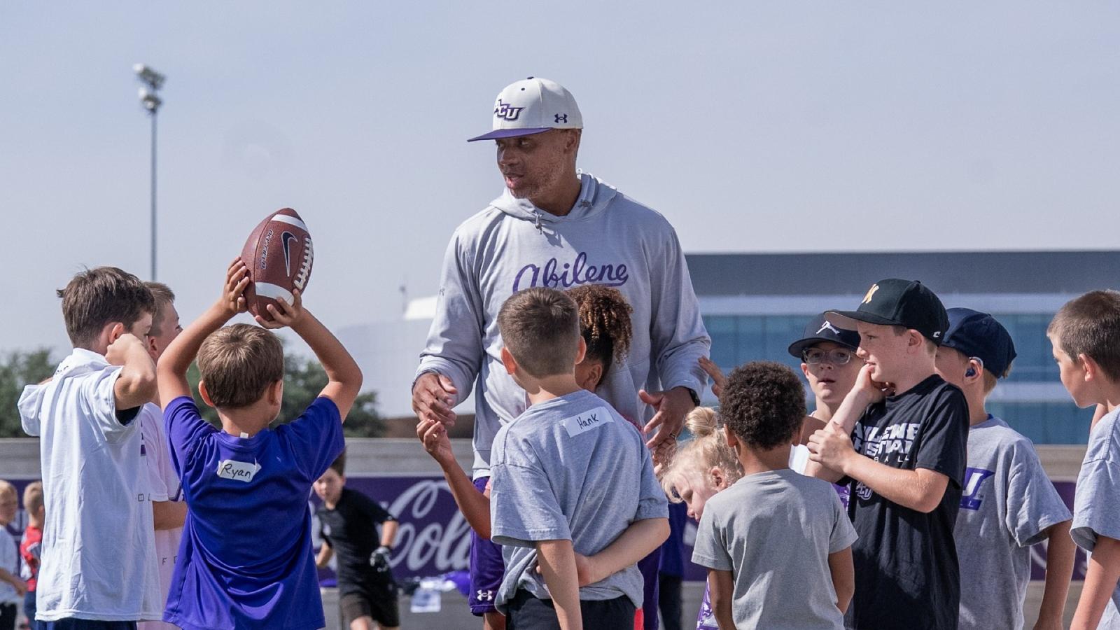 Graham Harrell talks to fans during a team gathering at a donor's house in Abilene in April 2026.