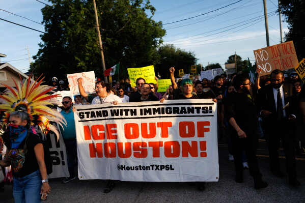 People march through the streets during a vigil for Lorenzo Salgado Araujo, a Mexican national fatally shot by a federal immigration agent a day prior, Wednesday, July 8, 2026, in Houston. (AP Photo/Mark Felix)