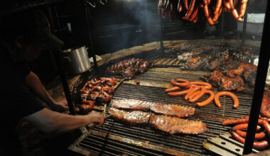 View of a chef cooking barbecued meats on an open-fire pit at the Salt Lick restaurant, Driftwood, Texas, December 14, 2015.