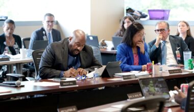 Parkland Hospital’s Board of Managers Chair Vincent Hall (center) reads a resolution before a vote was taken on whether to bail out Metrocare, the area’s largest mental health service provider, from its current financial crisis. The meeting was held at the Parkland Memorial Hospital WISH Clinic, 5200 Harry Hines Blvd., in Dallas on July 13 2026.