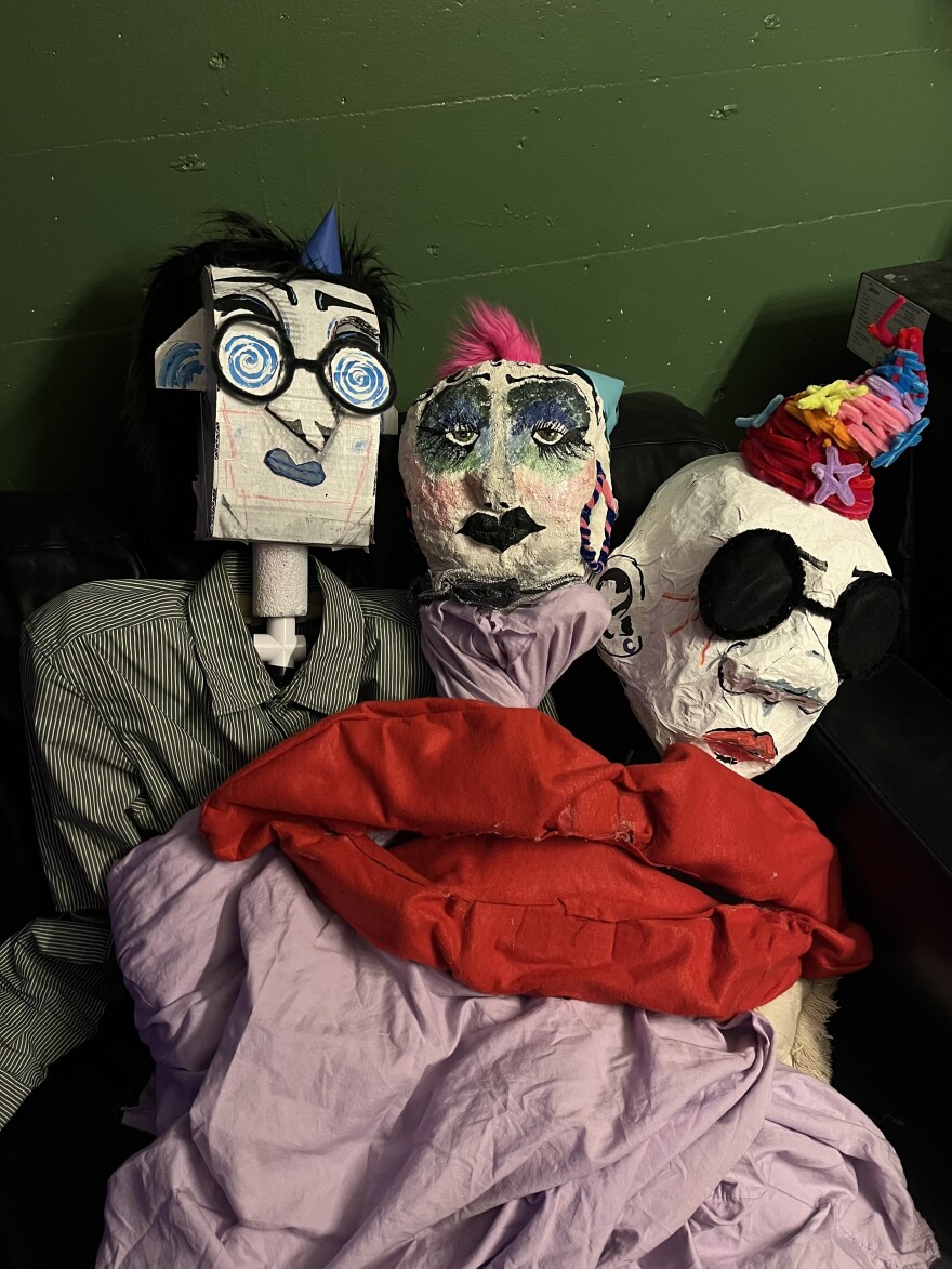 Three puppets are shown grouped together