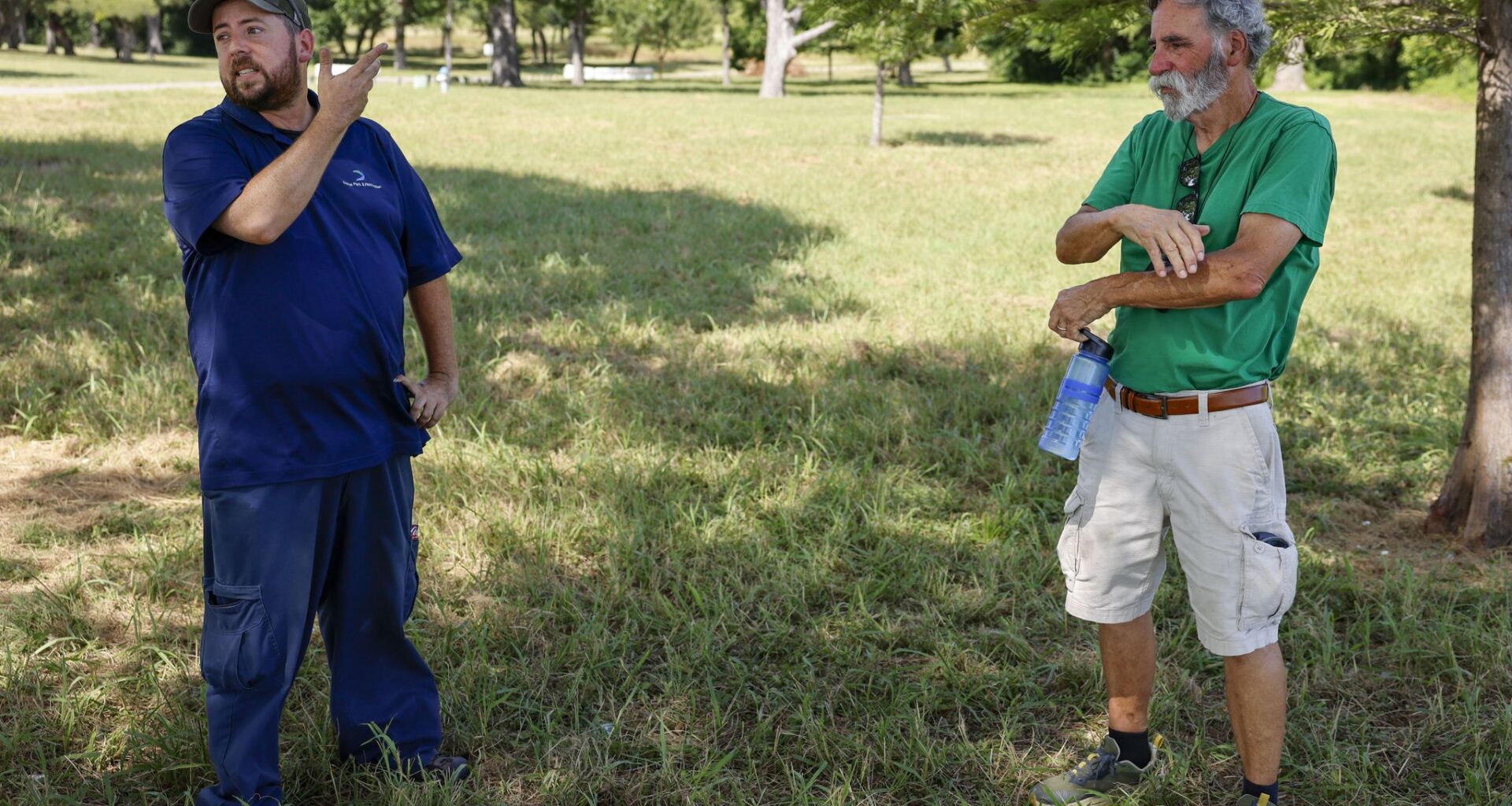 Chris Morris, Dallas Park and Recreation’s urban biologist (left), talks with Dallas resident Dick Morrison while watching bald eagles and their eaglets at White Rock Lake on Thursday, July 9, 2026, in Dallas.