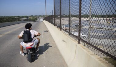 A Joppa resident on a motorbike looks toward the Austin Bridge & Road South Dallas Plant while riding over the Linfield Road bridge in Dallas on Wednesday, May 31, 2023.