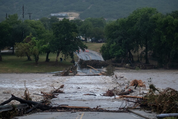 Flooding blocks off G Street along the Guadalupe River on Thursday, July 16, 2026, in Kerrville, Texas. (AP Photo/Joel Angel Juarez)