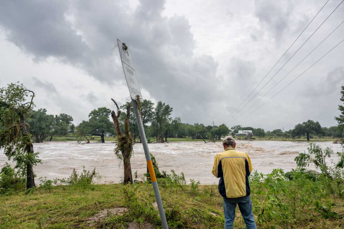 A person views the Guadalupe River after flash flooding occurred along its banks on July 16, 2026 in Center Point, Texas. Flash floods swept across parts of Central Texas, prompting evacuations and triggering multiple water rescues.