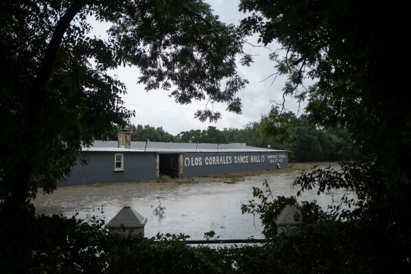 Los Corrales Dance Hall along State Highway 27 is flooded on Thursday, July 16, 2026, in Comfort, Texas. (AP Photo/Joel Angel Juarez)