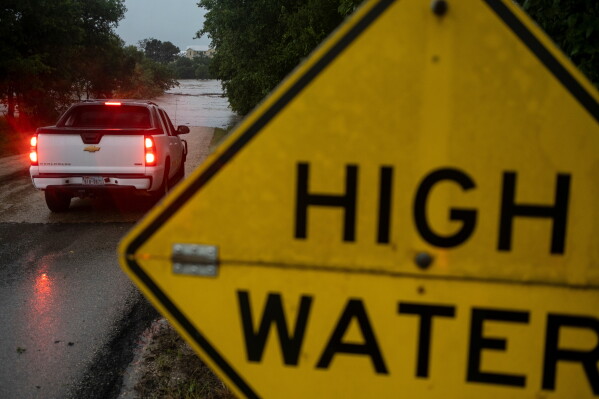 The Pedernales River floods near Old Kerr Highway on Thursday, July 16, 2026, in Fredericksburg, Texas. (AP Photo/Joel Angel Juarez)